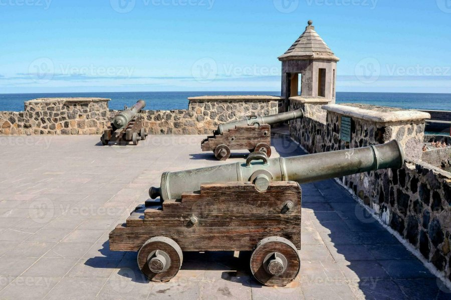 three-cannons-on-the-wall-of-a-castle-overlooking-the-ocean-photo.jpg
