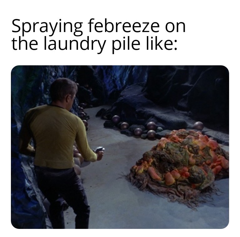 spraying-febreeze-on-laundry-pile-like
