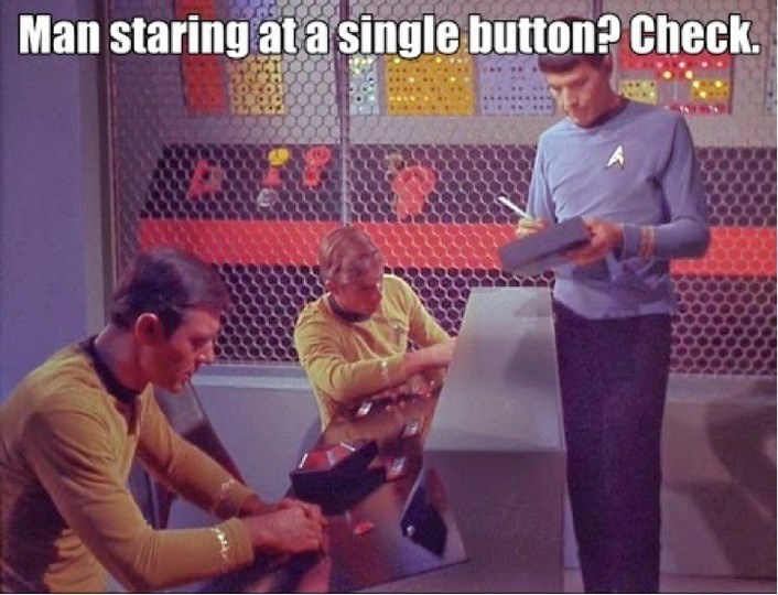 man-staring-at-single-button-check
